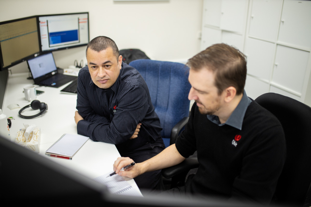 Two men discussing at a desk